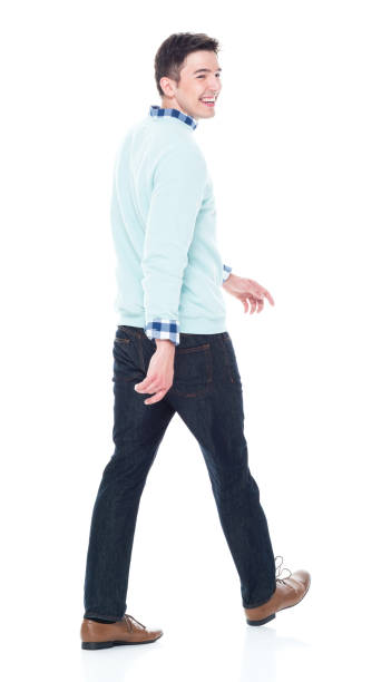 istock Handsome young man walking and looking behind, rear view. 1168666283