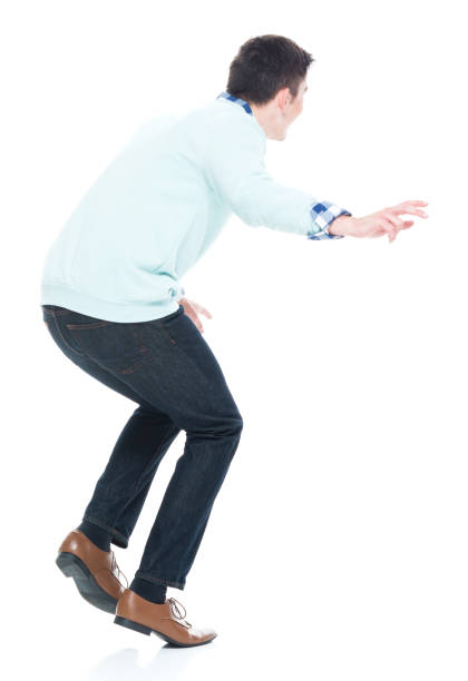 istock Handsome young man walking carefully. Rear view. 1168666288