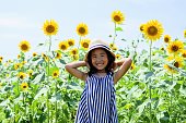 Girl smiles in the sunflower garden