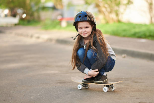 istock A little girl squats on a skateboard. 1168666989