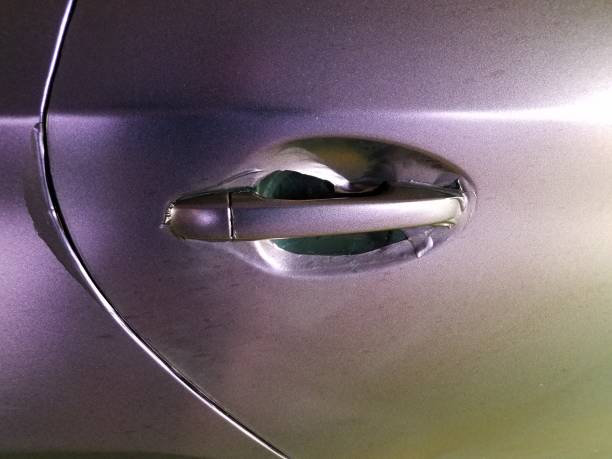 istock worn purple wrap on automobile with door handle 1168668175
