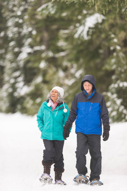 istock A senior couple snowshoeing in the forest 1168669052