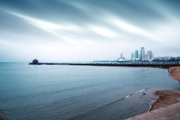 The trestle bridge by the sea, the Qingdao city landscape in the fog.