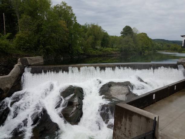 istock waterfall or rapids and rocks and building 1168671296
