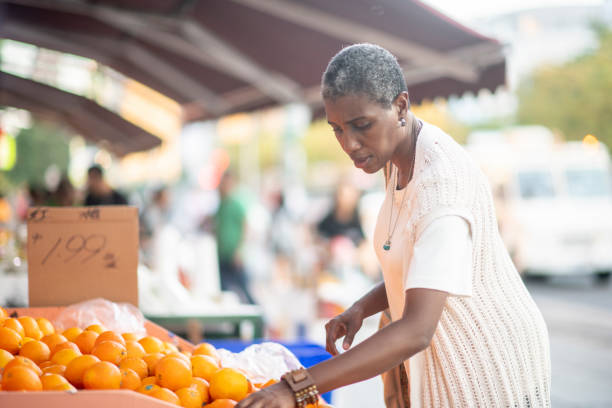 istock Senior woman buying oranges 1168671573