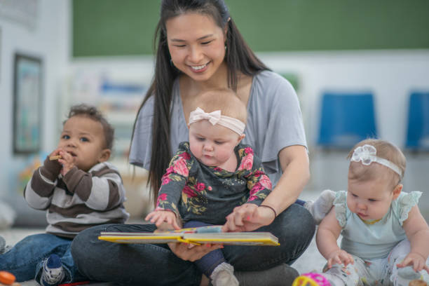 istock Preschool teacher reading to babies 1168671628