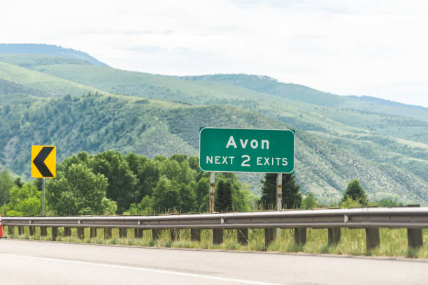 Freeway highway through Colorado towns with sign for Avon city in rocky mountains Freeway highway through Colorado towns with sign for Avon city in rocky mountains garfield county montana stock pictures, royalty-free photos & images