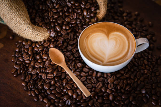 istock coffee latte with coffee beans  on dark background, top view 1168675849