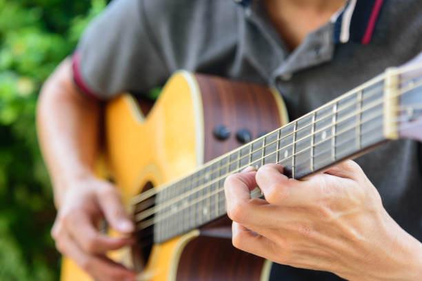 istock Playing acoustic guitar in the park 1168683667