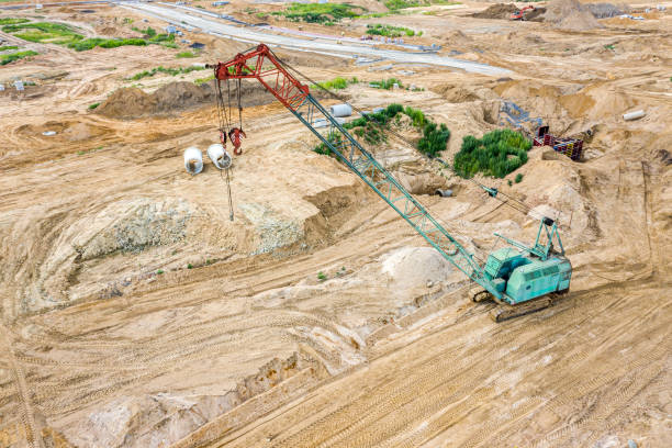 istock large industrial crawler crane at construction site. aerial view 1168695273