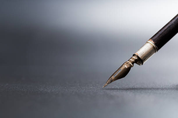 istock Old fountain pen on a black textured background 1168695280