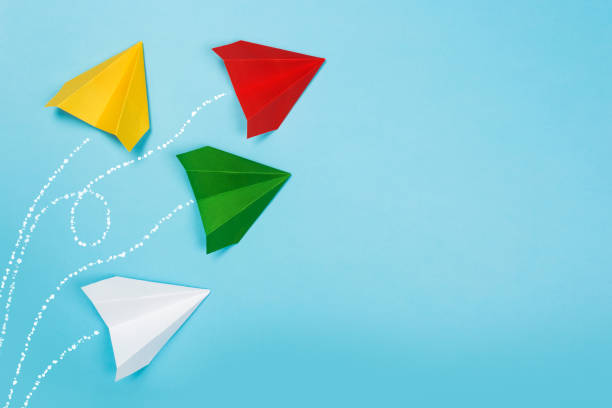 istock Color paper airplanes on blue background. top view 1168695283