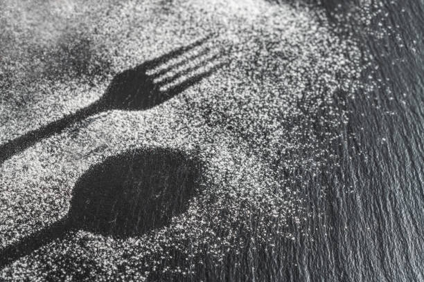istock Spoon, fork silhouette made with flour on dark texture background, up horizontal view 1168696381