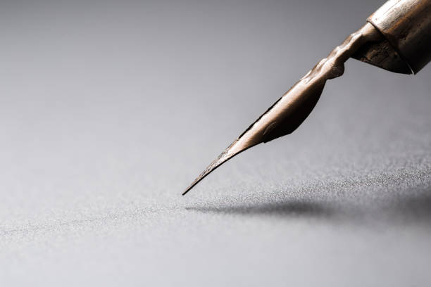 istock Old fountain pen on a black textured background 1168696496