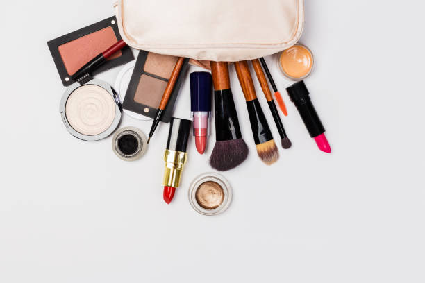 istock Makeup products with cosmetic bag and macaroons on light background 1168696584