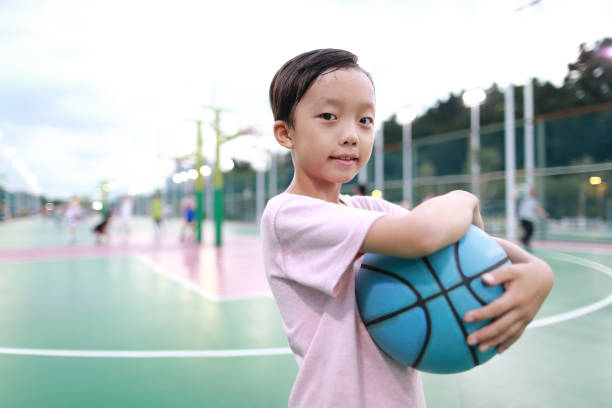 istock Cute little boy playing basketball 1168699606
