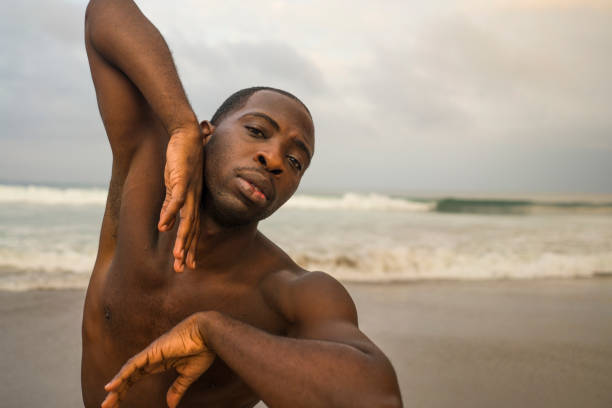 istock contemporary dance choreographer and dancer doing ballet beach workout . a young attractive and athletic black African American man dancing on sunrise doing dramatic performance 1168701288