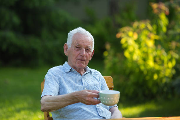 istock Senior man drinking tea in garden 1168702231