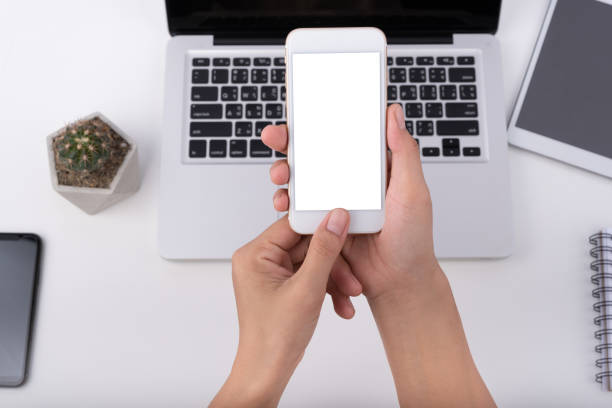 istock hand holding phone mobile and touching screen isolated on white background 1168706291