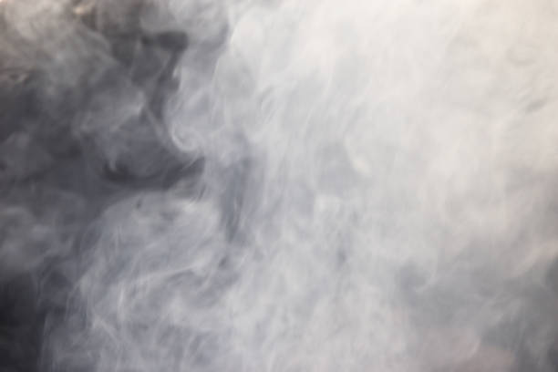 istock Blurry white mist or smoke or steam on black background 1168707078