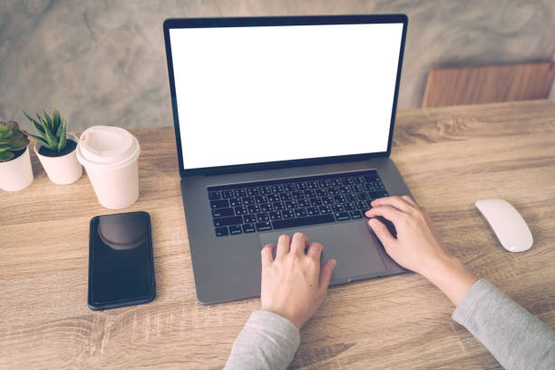 istock Business woman using laptop computer do online activity on wood table at home office. 1168708236