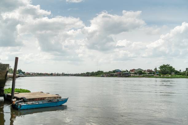 istock small blue boat on the river with sky and cloud. 1168710447