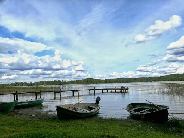 Row boats with summer lake landscape in Finland