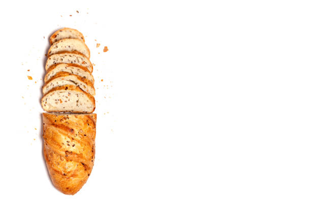 istock Top view from above - half sliced homemade wheat grain fresh gluten free bread, space for text, isolated on white background. Copyspace. Food concept, flat lay composition 1168716738