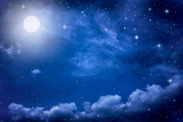 istock Starry night sky with stars and moon in cloudscape background 1168717189