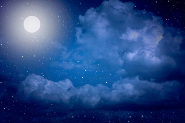 istock Starry night sky with stars and moon in cloudscape background 1168717199