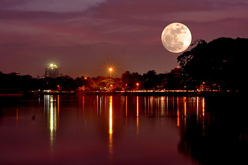 Dramatic view of the super moon from a lakeside