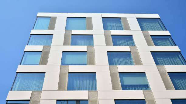 istock Modern office building with reflection in windows of building 1168718037