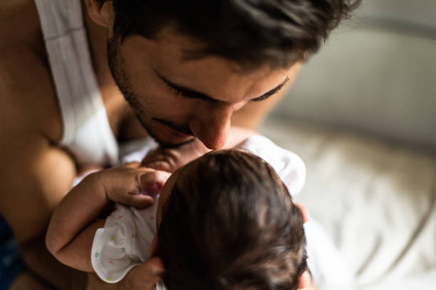 istock Father holding newborn baby 1168718096