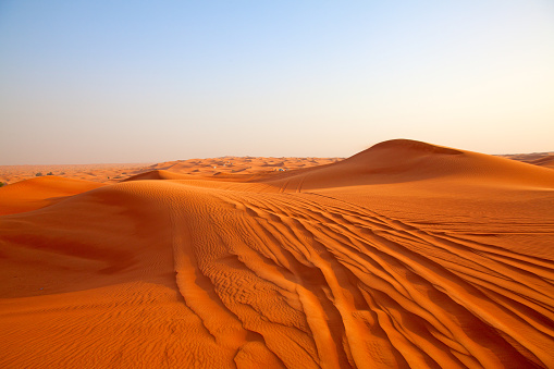 Sand dunes of Qatar desert at sunset time