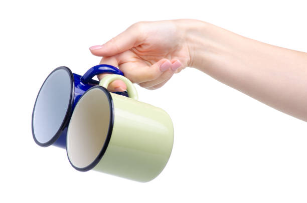 istock Green and blue enamel cup in hand 1168723733