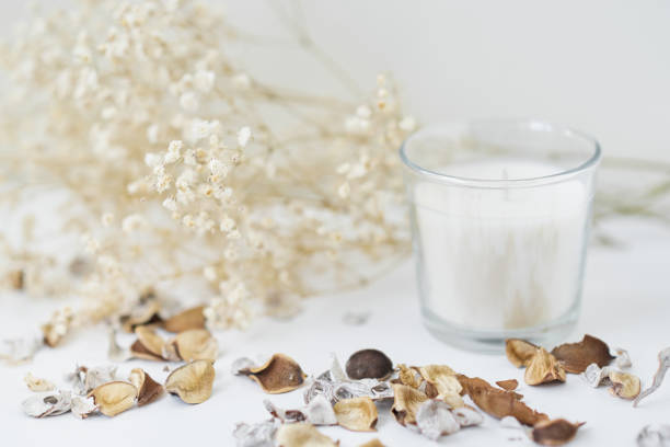 istock Candles with floral decor on a white table. Cozy and hygge background 1168723822