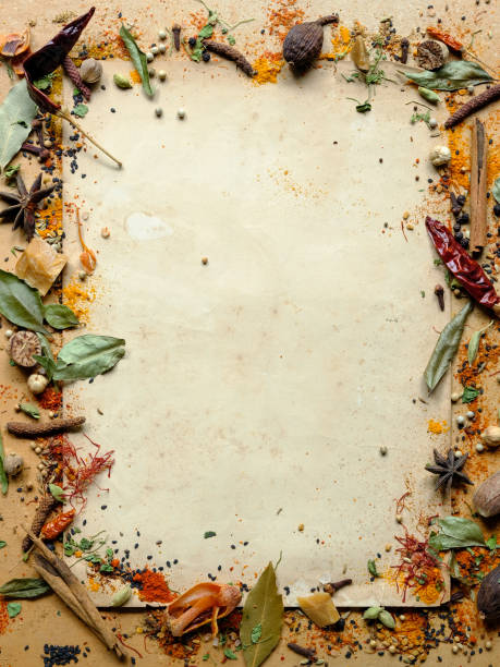 Variety of colorful, dried, vibrant Indian food spices around a vintage piece of paper in the center of the image. A variety of colorful, dried, vibrant Indian food spices on a rustic ceramic background laid out around a vintage piece of paper in the center of the image. Good copy space for text. healthy indian food stock pictures, royalty-free photos & images