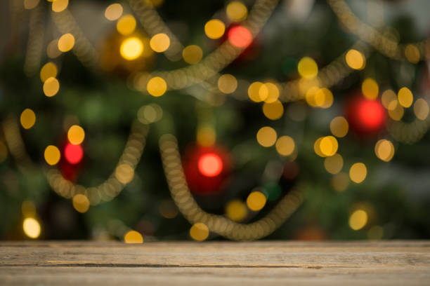 istock rustic wood table in front of christmas light night, abstract circular bokeh background 1168725546