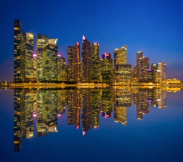 istock Singapore Downtown skyline at night with reflection. Financial district and business centers in technology smart urban city in Asia. Skyscraper and high-rise buildings. 1168726943
