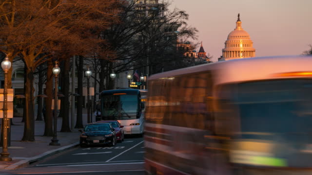 Time-lapse: US Capitol Building with transportation light from Freedom Square in Washington DC, USA at sunset twilight