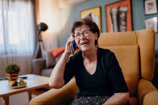 istock Portrait of senior woman at home using mobile phone and technologies 1168727951