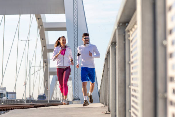 istock Couple jogging at the bridge 1168729220