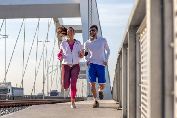 istock Couple jogging at the bridge 1168729222