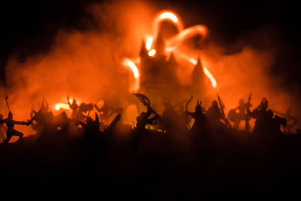 istock Medieval battle scene with cavalry and infantry. Silhouettes of figures as separate objects, fight between warriors on dark toned foggy background with medieval castle. 1168731900