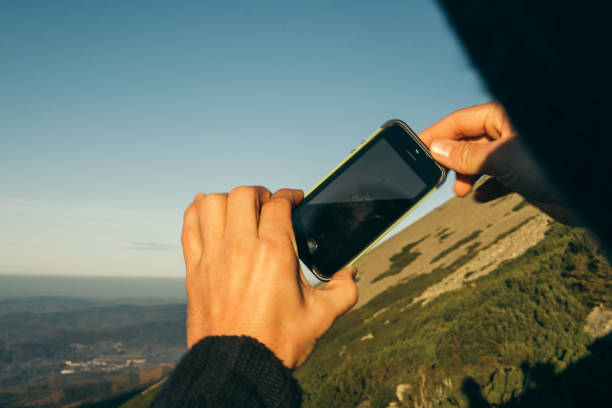 istock Man admiring mountain landscape. Taking photo 1168733052