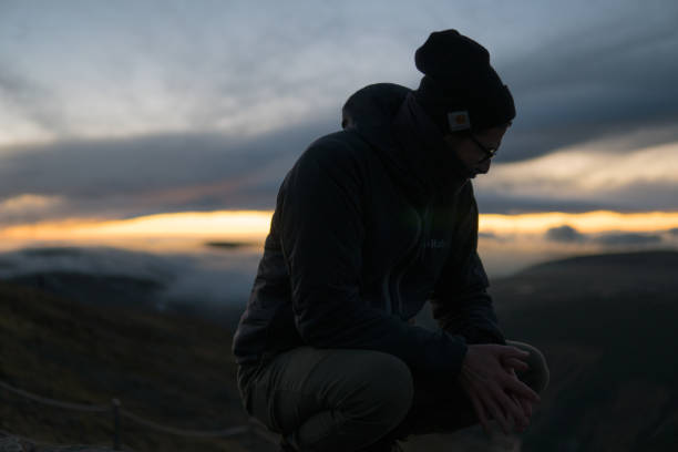 istock Tourist's silhouette and mountain sunset 1168734273