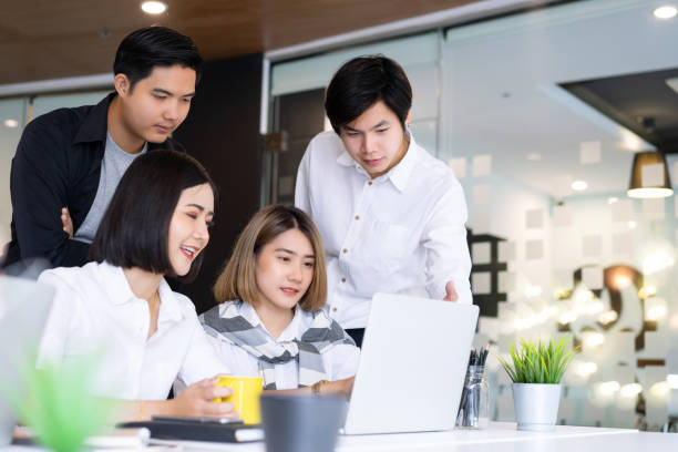 istock Diverse startup young business people group working together on laptop at modern office. 1168735445