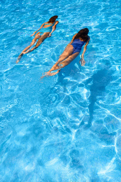 istock Two women diving in a swimming pool 1168735984
