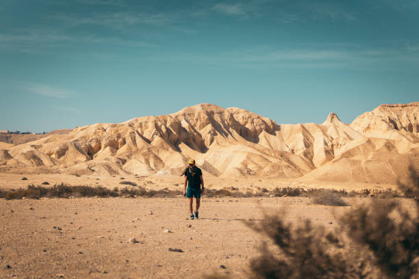 Lone man walking along mountain trails