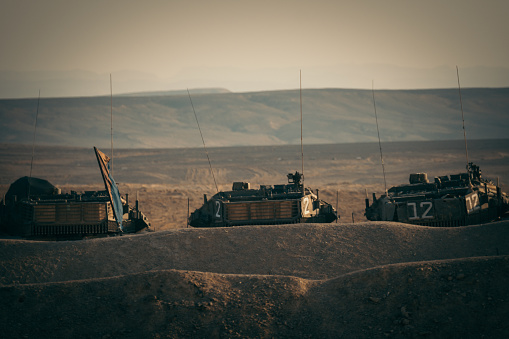 Old tanks standing on a sand
